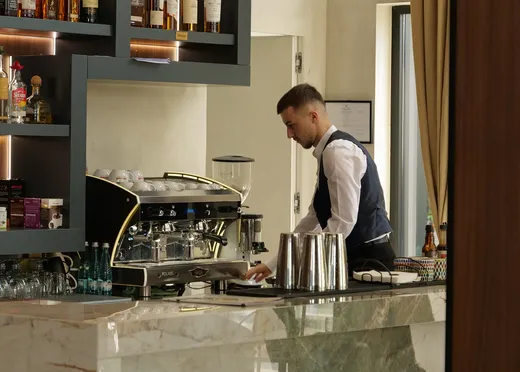A barman preparing drinks at the Mercure Tirana bar